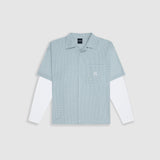 Checkered double sleeve shirt with light green, blue, and white plaid body, off-white contrast sleeves, boxy fit, and embroidered monogram on the chest pocket.