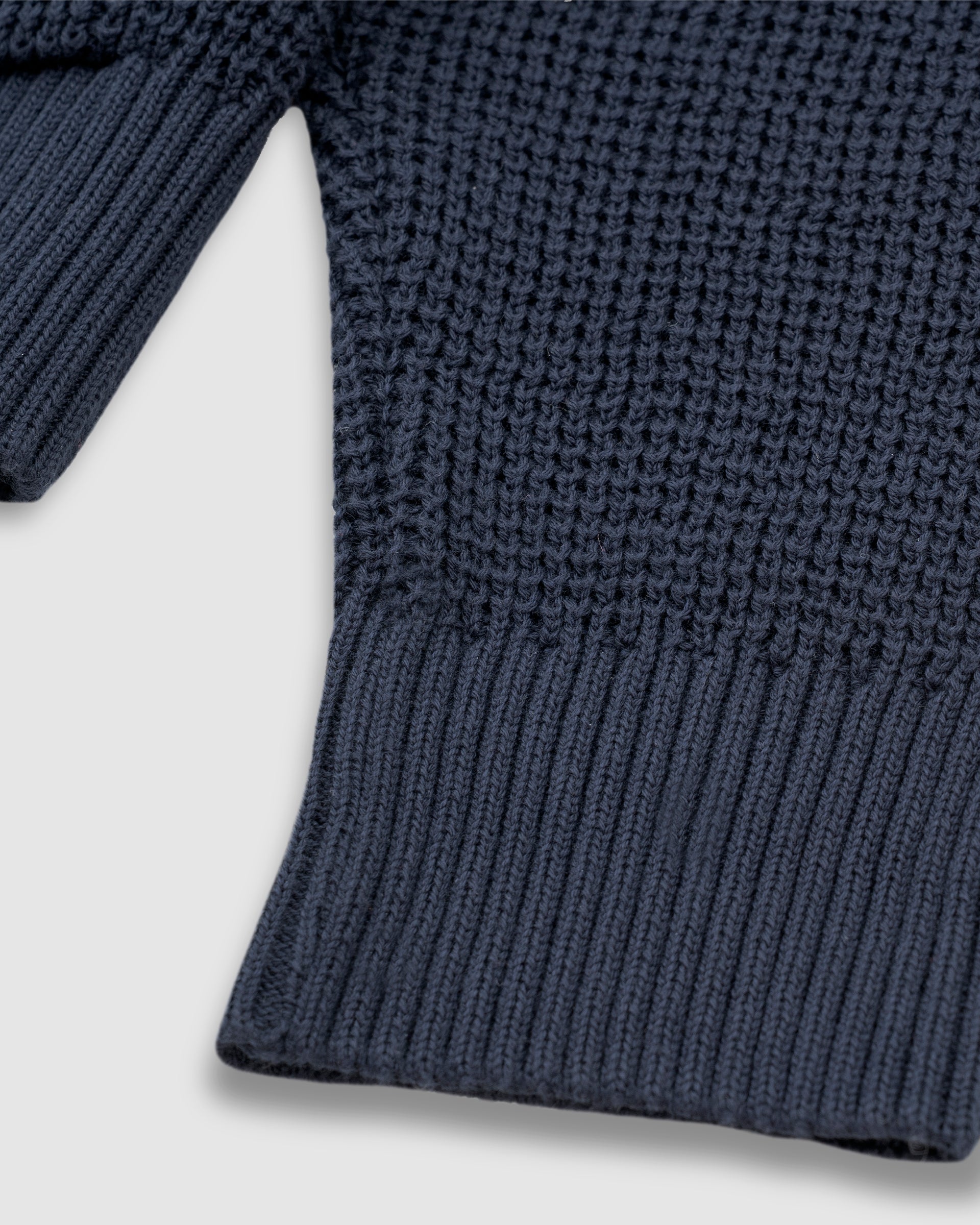 Zip Knitwear Hoodie in Navy Blue with metallic monogram, kangaroo pocket, and double zipper.