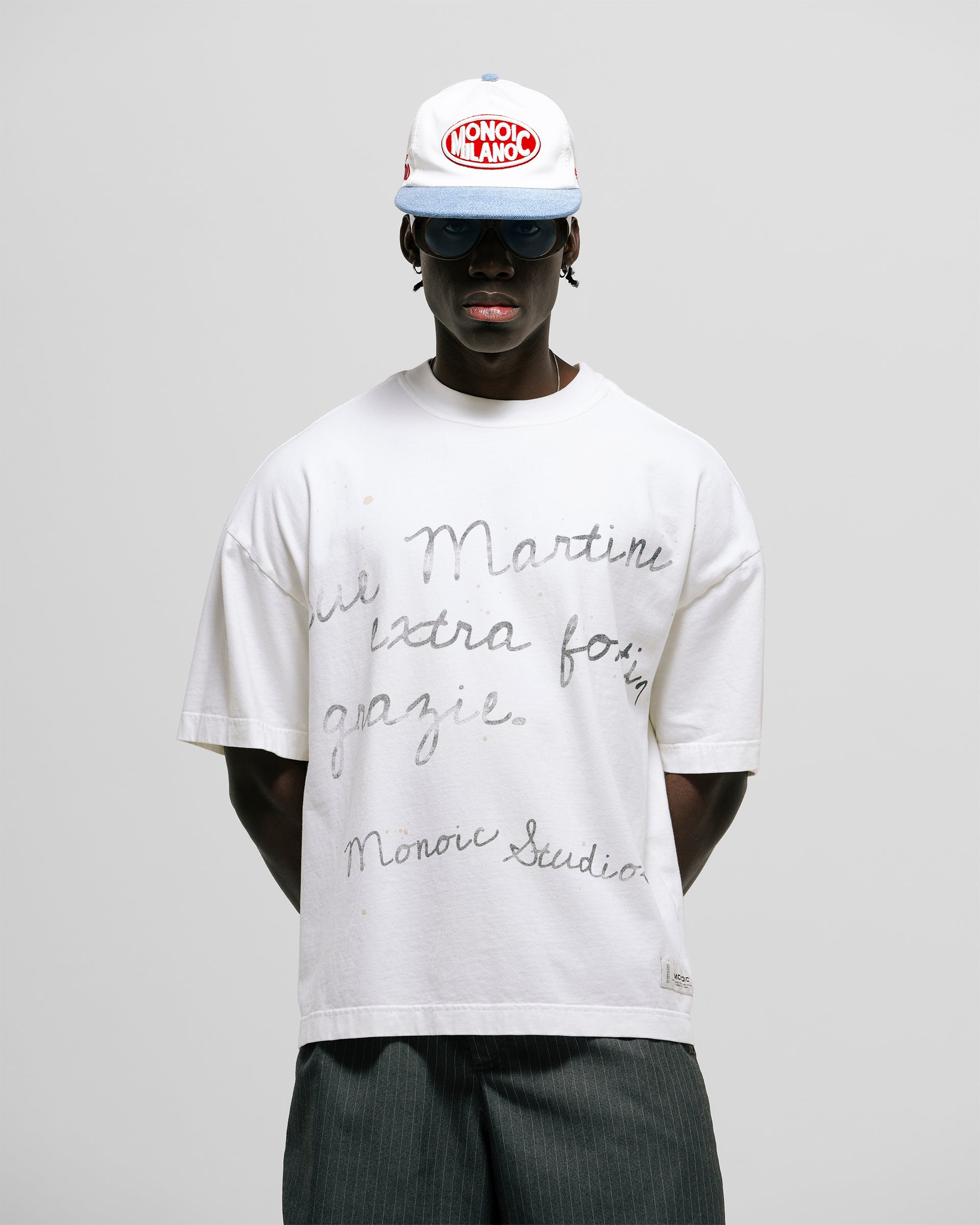 Egret White Boxy Fit T-Shirt with distressed screen-print and coffee-splatter effect, featuring woven Monoic side label.