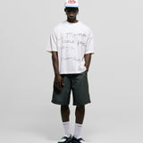 Egret White Boxy Fit T-Shirt with distressed screen-print and coffee-splatter effect, featuring woven Monoic side label.