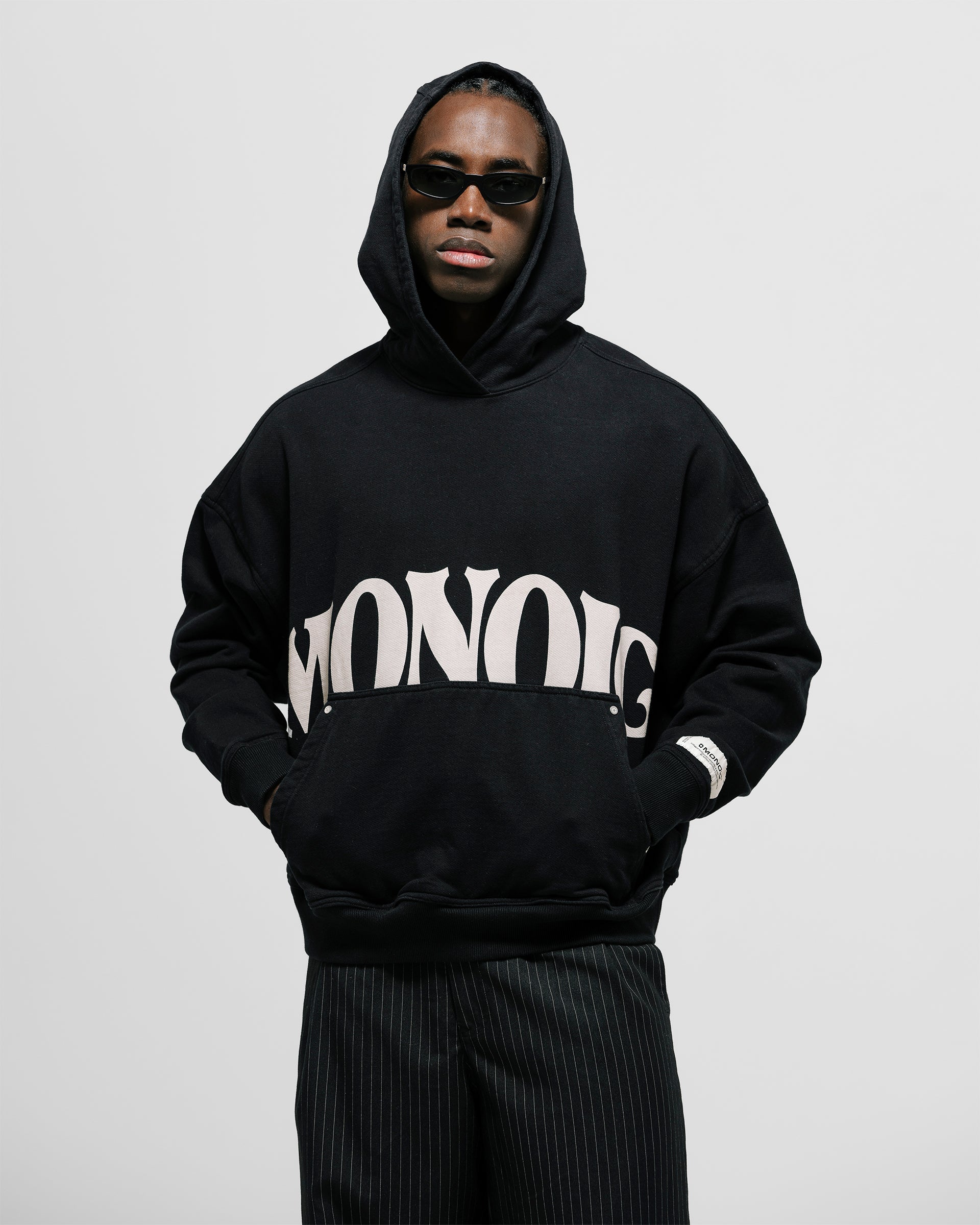 Hoodie La Vita È Bella in Dark Black with raised back print, kangaroo pocket, and metallic details.
