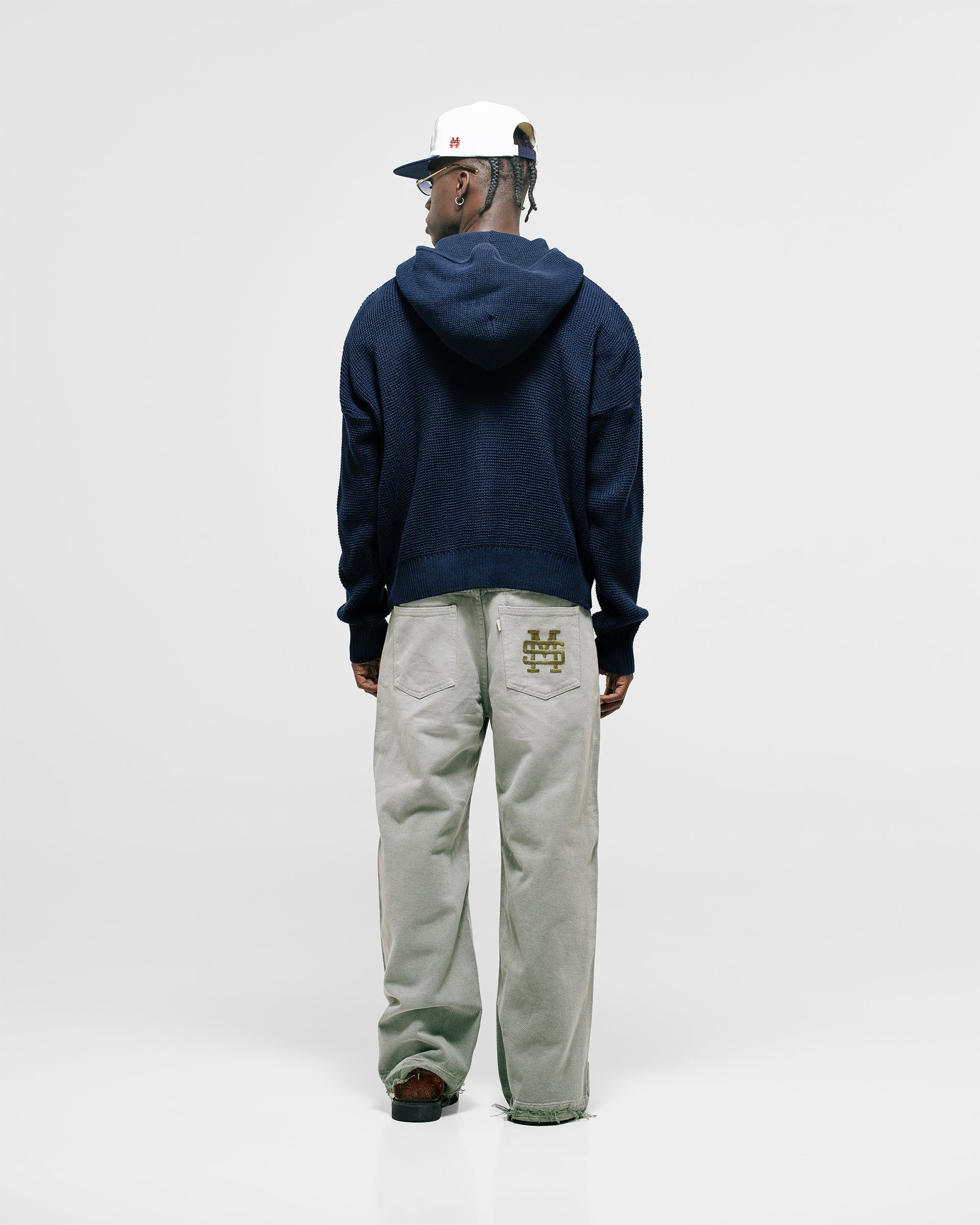 Zip Knitwear Hoodie in Navy Blue with metallic monogram, kangaroo pocket, and double zipper.